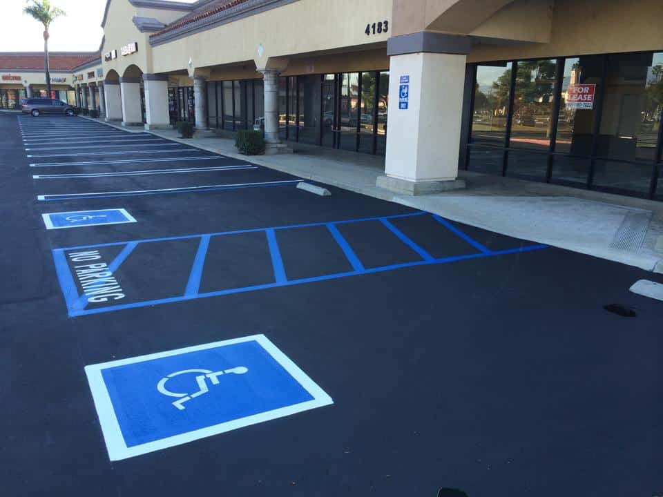 Hot rubberized sealant applied to cracks at Maple Lane Plaza.