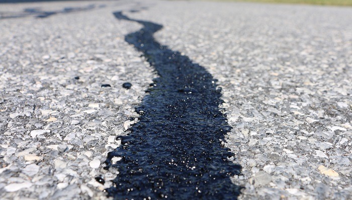 Hot pour crack filling process commercial parking lot Michigan