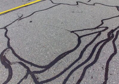 Cracked asphalt pavement showing damage that signals the need for repaving