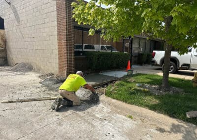 Morelli – Clinton Township, Michigan 32 Construction worker smoothing wet concrete in a trench
