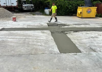 Morelli – Clinton Township, Michigan 28 Man walking across a concrete yard with freshly laid concrete in a cross pattern