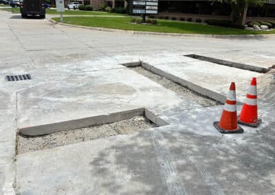 Morelli – Clinton Township, Michigan 26 Concrete street with trench openings exposing gravel and traffic cones