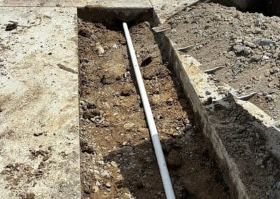 Morelli – Clinton Township, Michigan 22 Trench with PVC pipe installation along a concrete sidewalk