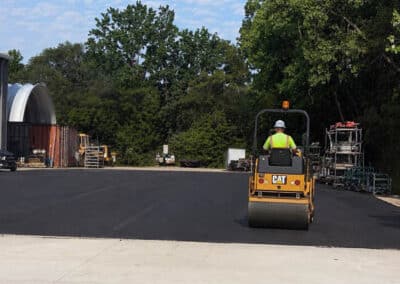 Morelli – Clinton Township, Michigan 19 Worker operating a CAT road roller on freshly laid asphalt