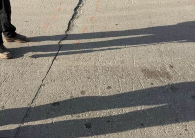 Morelli – Clinton Township, Michigan 4 Concrete pavement with a large crack and orange markings