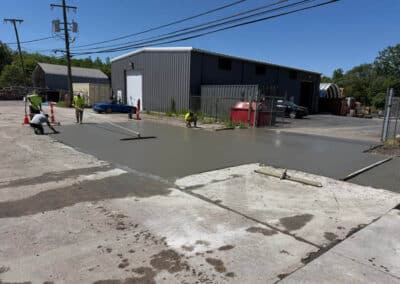 Morelli – Clinton Township, Michigan 17 Workers smoothing a freshly poured concrete slab using a screed and float