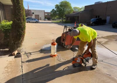 Morelli – Clinton Township, Michigan 12 Workers cutting concrete sidewalk in a parking lot